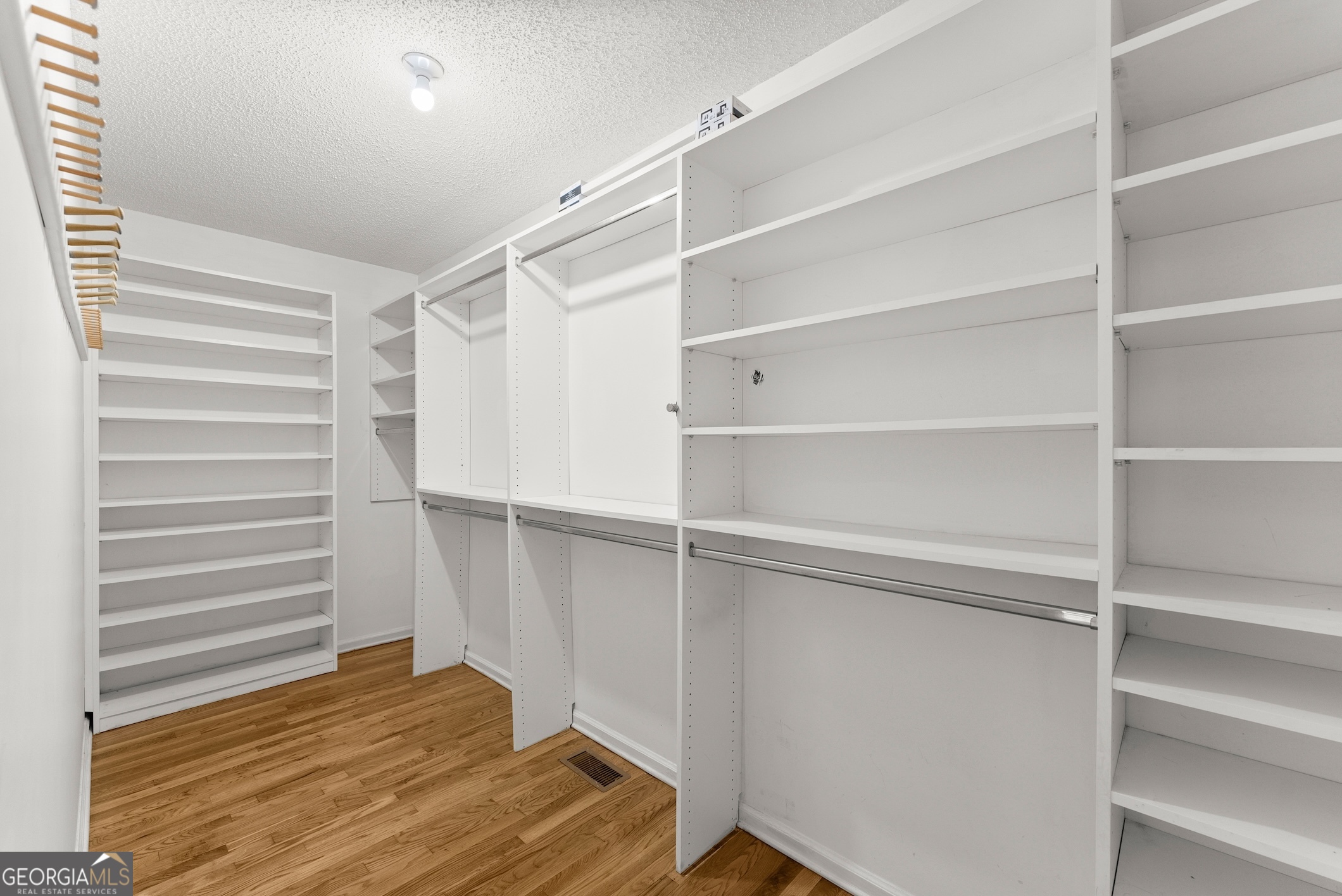 81 Heather Way Cleveland, GA 30528 - Photo 17 of 49 a view of walk in closet with empty racks