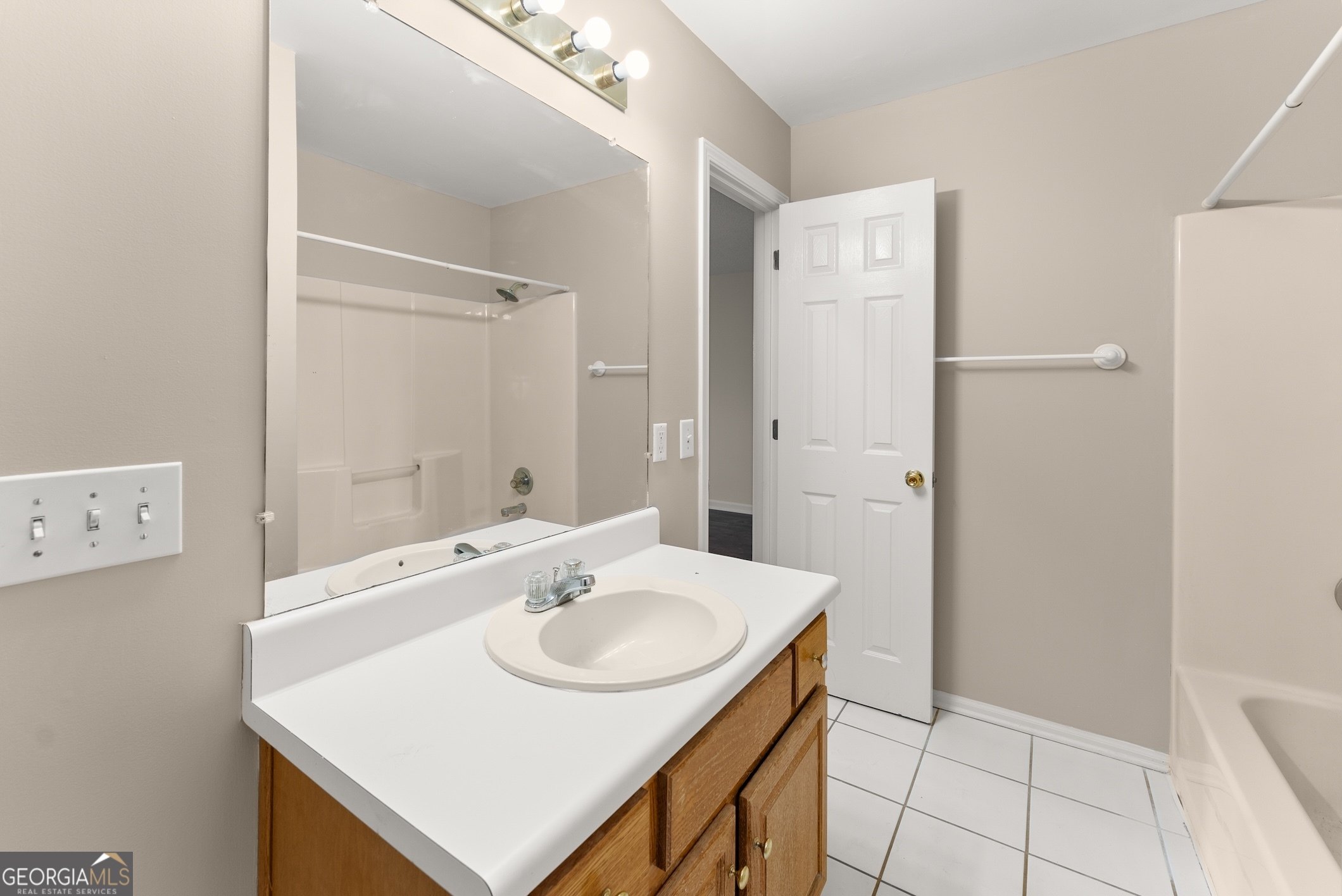 81 Heather Way Cleveland, GA 30528 - Photo 25 of 49 a bathroom with a sink a mirror and a shower