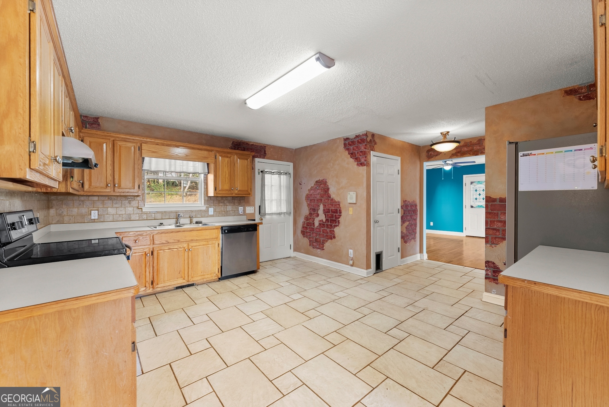 81 Heather Way Cleveland, GA 30528 - Photo 5 of 49 a large white kitchen with a sink a refrigerator and window