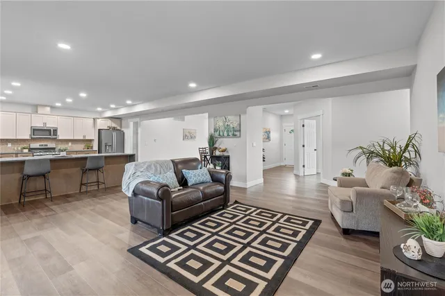 a living room with furniture rug and a table