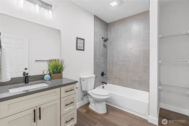 a bathroom with a granite countertop toilet a sink and a bathtub