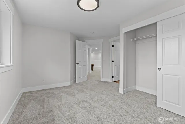 a view of an empty room and wooden floor