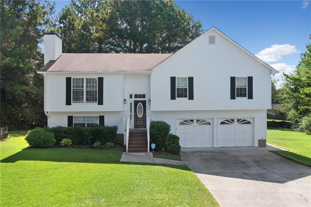 2778 Water Valley Road Austell, GA 30106 - Photo 1 of 1 a front view of a house with a yard and garage