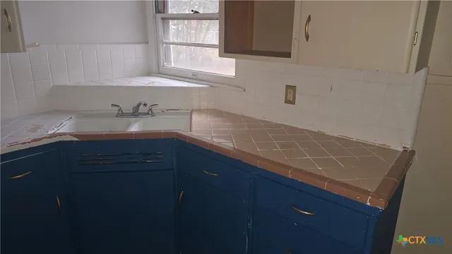 a kitchen with a sink and a window