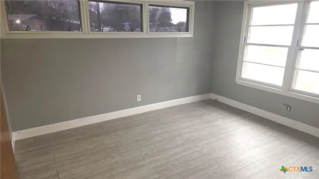 a bathroom with a toilet sink and window