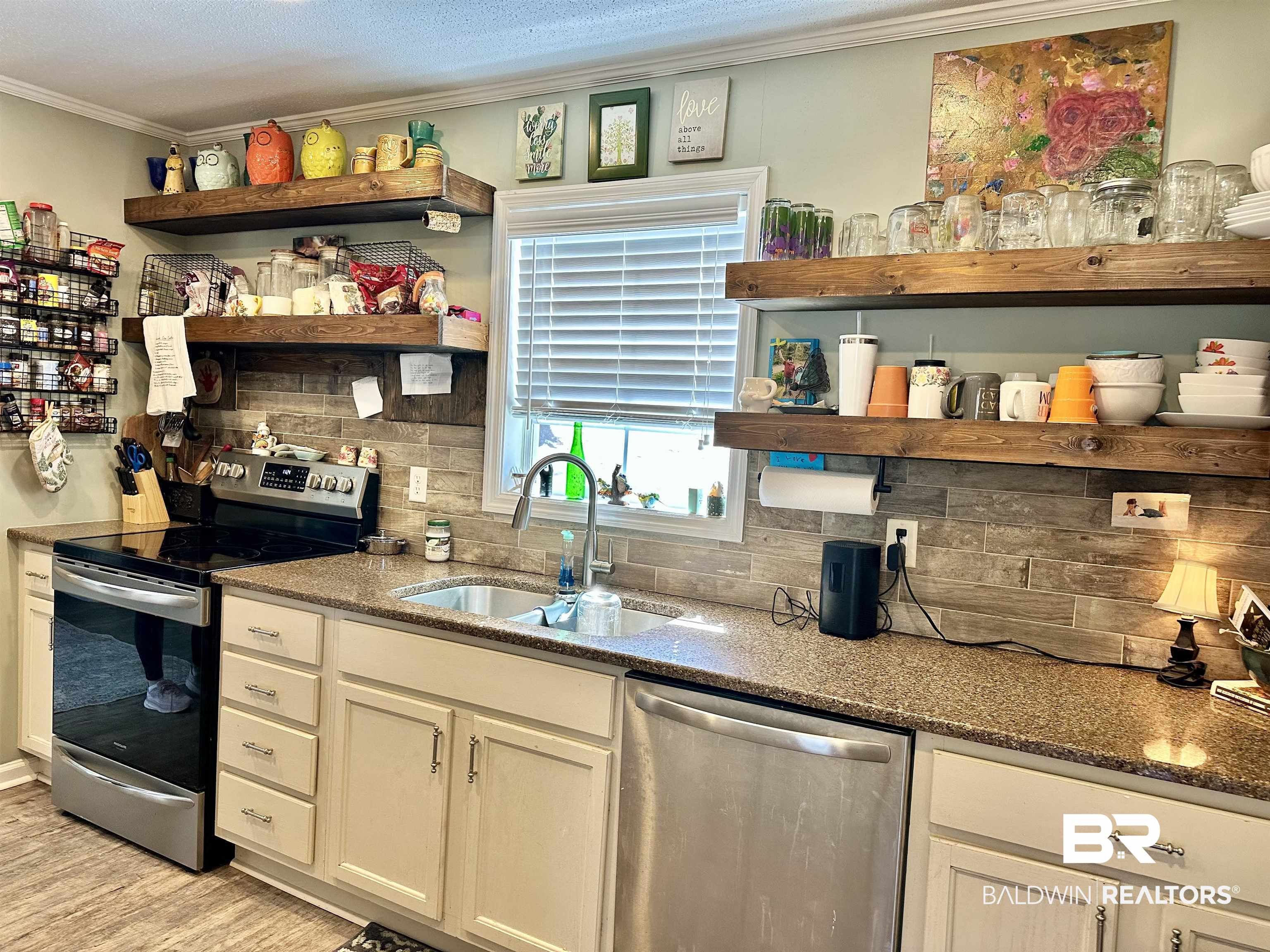 120 McGougin Road Brewton, AL 36426 - Photo 6 of 21 Kitchen with a sink, appliances with stainless steel finishes, decorative backsplash, open shelves, and crown molding