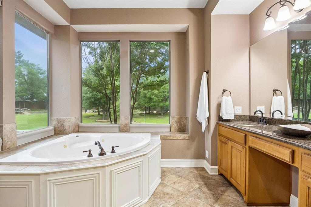 5802 Corinth Chapel Road Parker, TX 75002 - Photo 20 of 39 This jetted tub is surrounded by windows thatoverlook the gorgeous backyard. No privacyworries with motorized shades! Tile surround offersspace for lotions and potions.