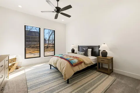 a bedroom with a large bed and a window