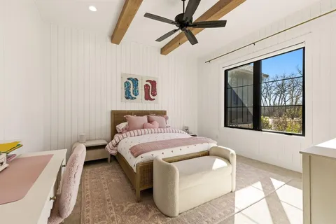 a bedroom with a bed and a painting on the wall