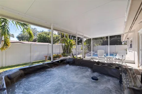 a view of a house with backyard and sitting area