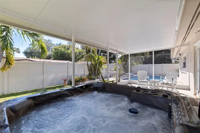 a view of a house with backyard and sitting area