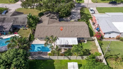 an aerial view of a house with a yard and garden