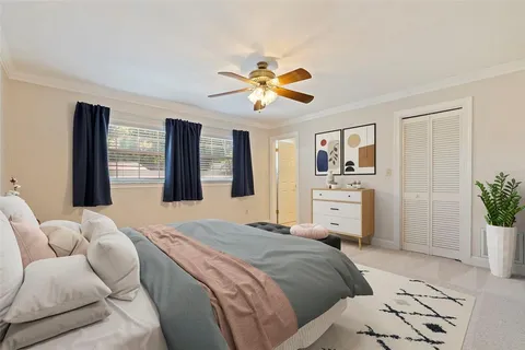 a spacious bedroom with a bed and a chandelier