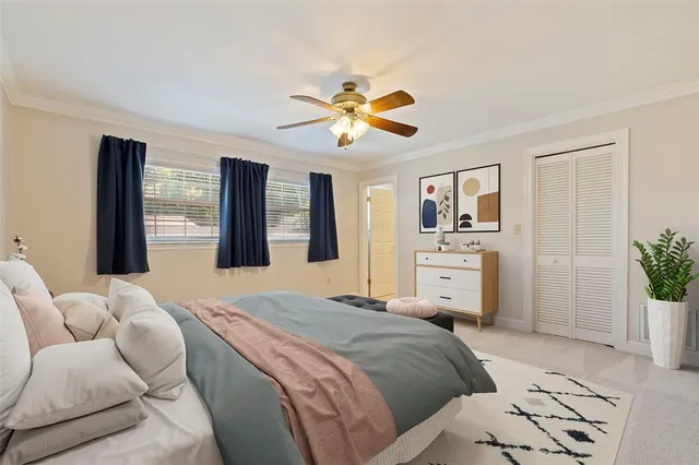 a spacious bedroom with a bed and a chandelier