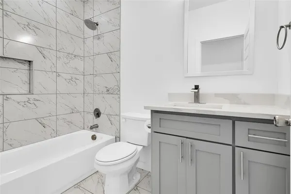 a bathroom with a sink a toilet and bathtub