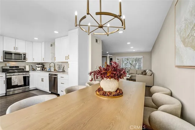 a view of a dining room with furniture and a kitchen
