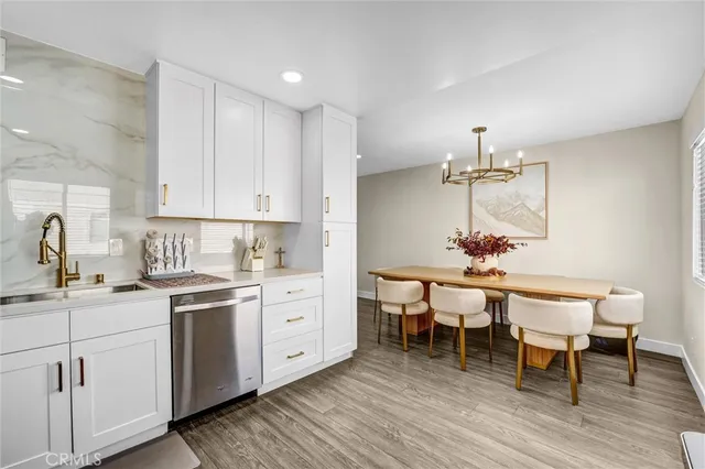 a kitchen with a dining table chairs and white appliances