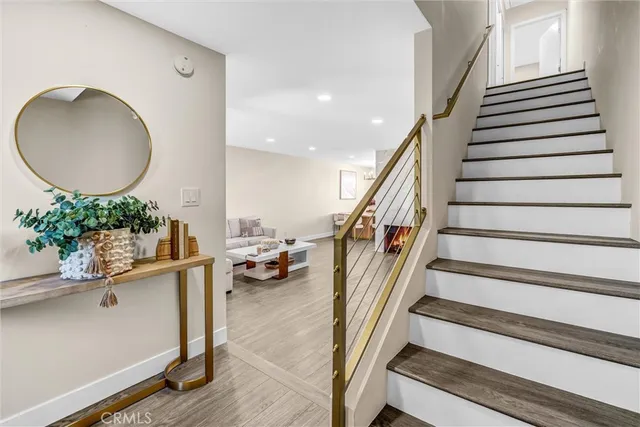 a view of entryway and hall with wooden floor