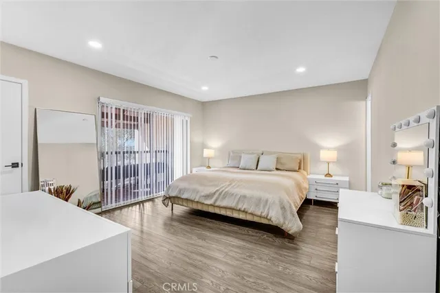 a spacious bedroom with a bed and a large window