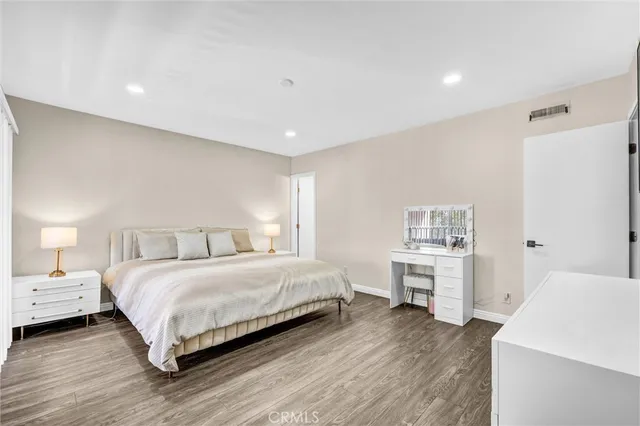 a bedroom with a bed and a desk