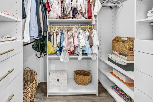 a living room with furniture and a painting on the wall