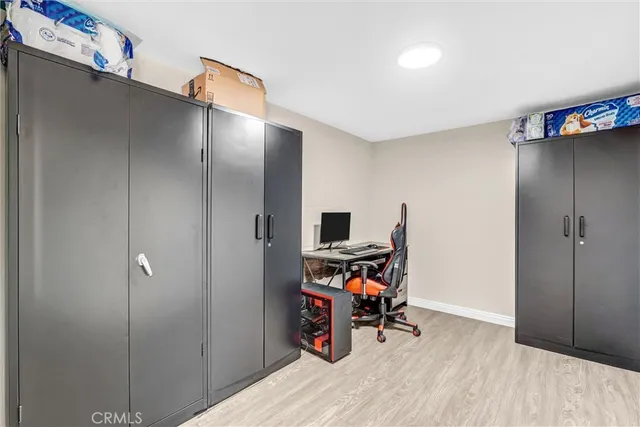 a view of a workspace with furniture and wooden floor