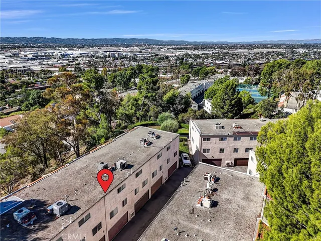 an aerial view of residential houses with outdoor space