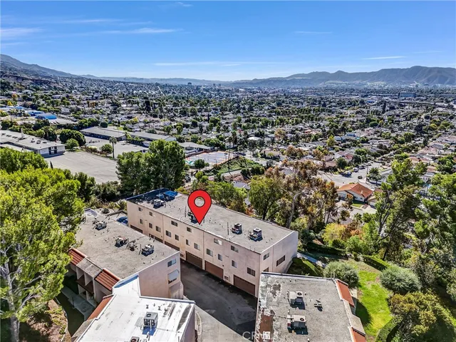 an aerial view of a houses with a city view