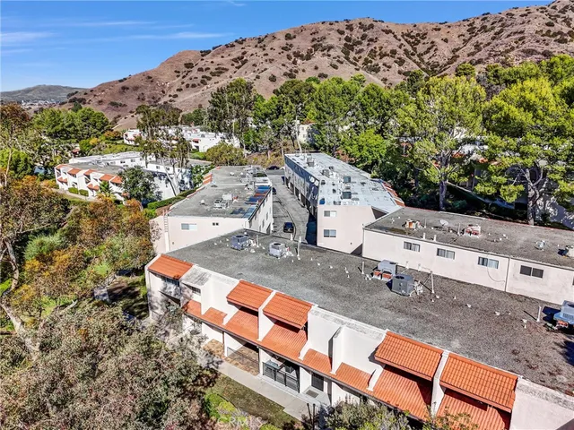an aerial view of a house with a yard
