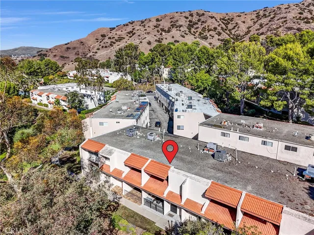 an aerial view of a house with a yard