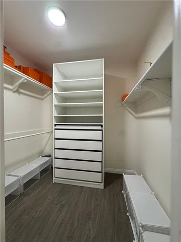 a view of walk in closet with empty racks