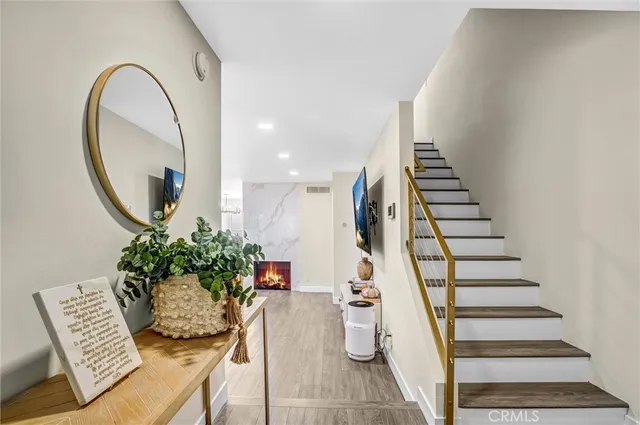 a view of a living room with furniture and wooden floor