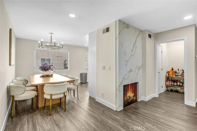a dining room with furniture a chandelier and wooden floor