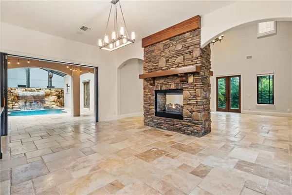 a view of an empty room with a fireplace and a window