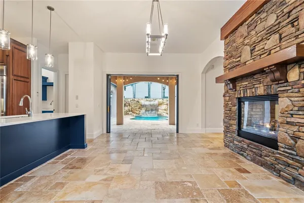 a view of kitchen with stainless steel appliances granite countertop a refrigerator and a stove top oven
