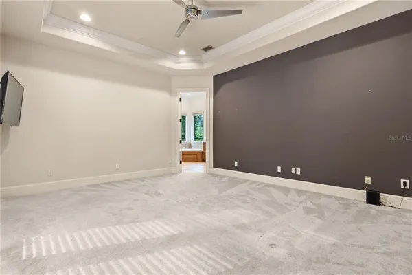 an empty room with windows and a flat screen tv