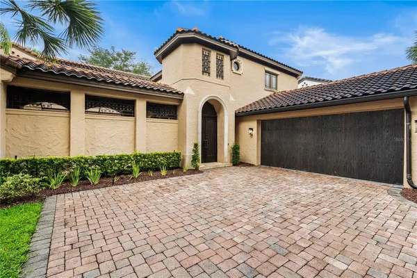 a front view of a house with a yard and a garage