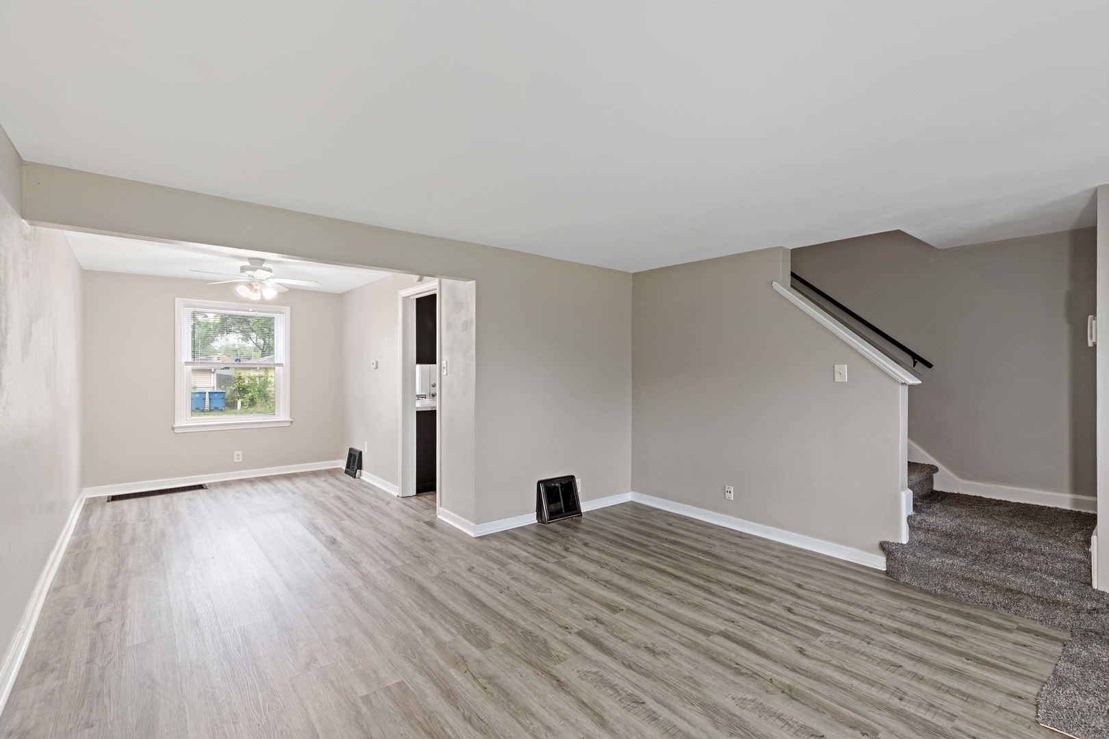1404 Wentworth Avenue, Unit 1 Calumet City, IL 60409 - Photo 3 of 14 an empty room with wooden floor and windows