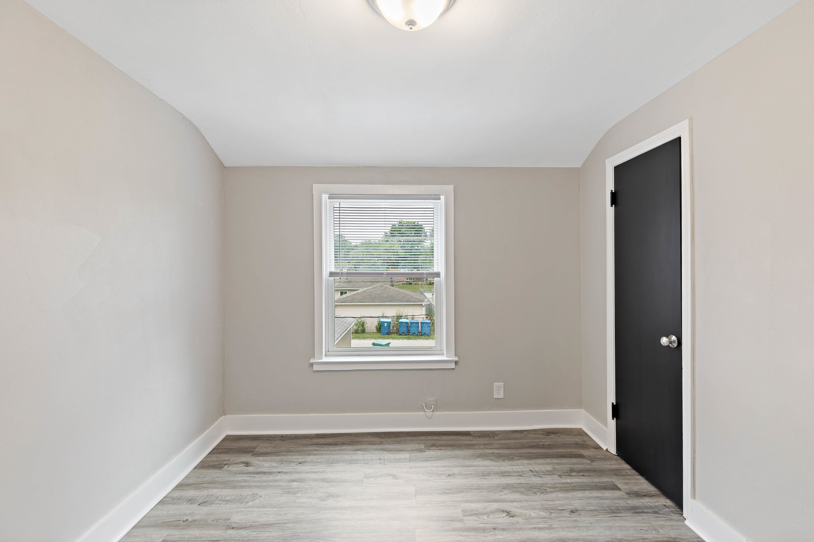 1404 Wentworth Avenue, Unit 1 Calumet City, IL 60409 - Photo 4 of 14 an empty room with wooden floor and windows