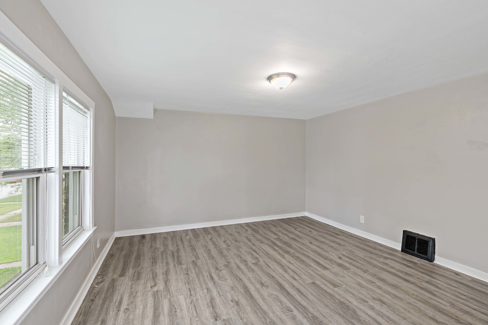 1404 Wentworth Avenue, Unit 1 Calumet City, IL 60409 - Photo 8 of 14 wooden floor in an empty room with a window