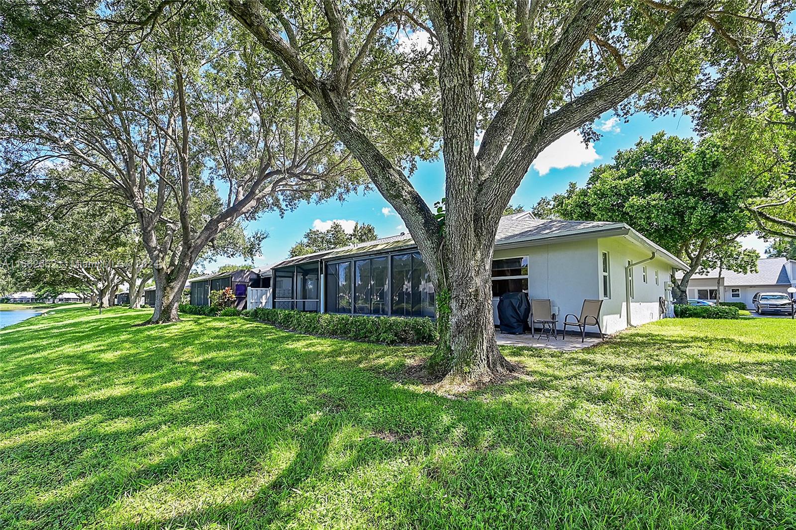 8913 Windtree Street Boca Raton, FL 33496 - Photo 23 of 30 Outdoor patio alongside lanai (BBQ area)