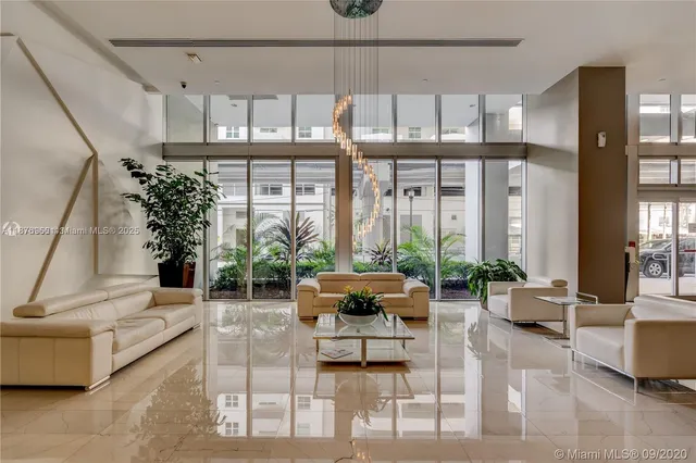 a living room with furniture and large windows