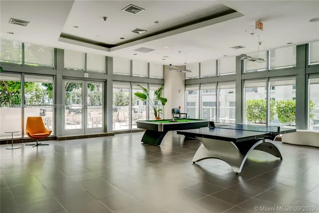 a living room with furniture and large windows