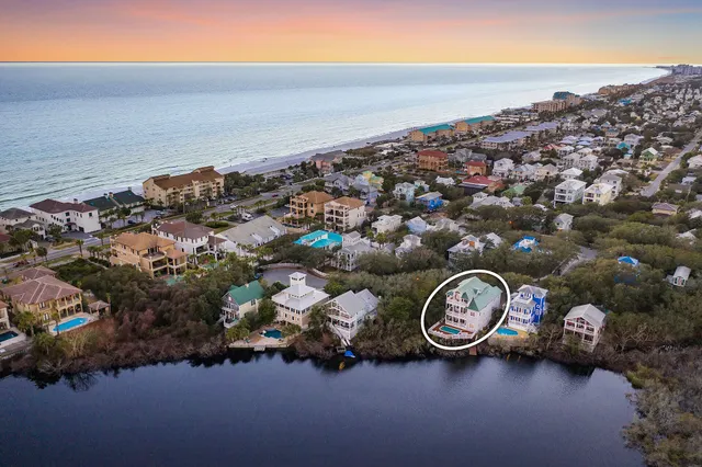 an aerial view of a house with swimming pool and mountain view