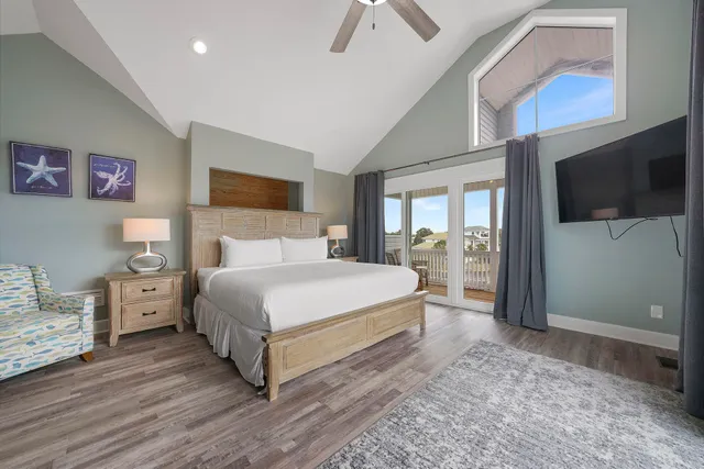 a bedroom with a large bed and a chandelier