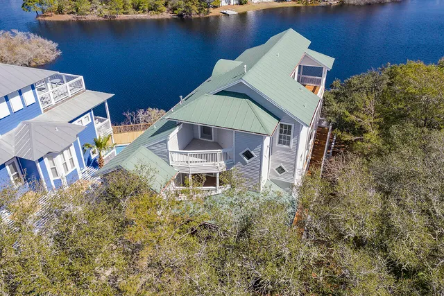 a yellow house with trees in front of it
