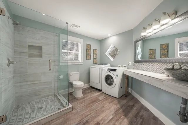 a spacious bedroom with a bed and a chandelier