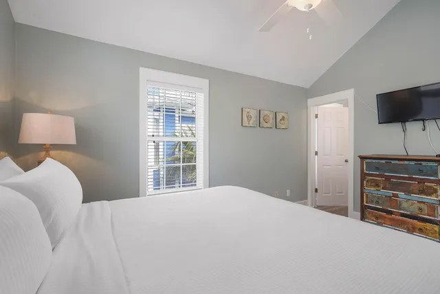 an aerial view of a house with a garden and lake view in back