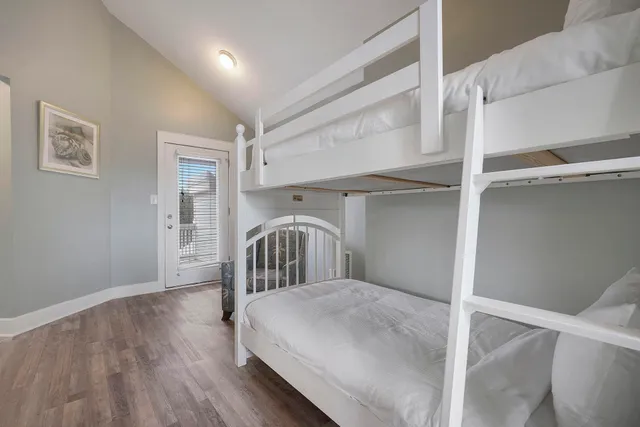 an aerial view of a house with a garden and lake view