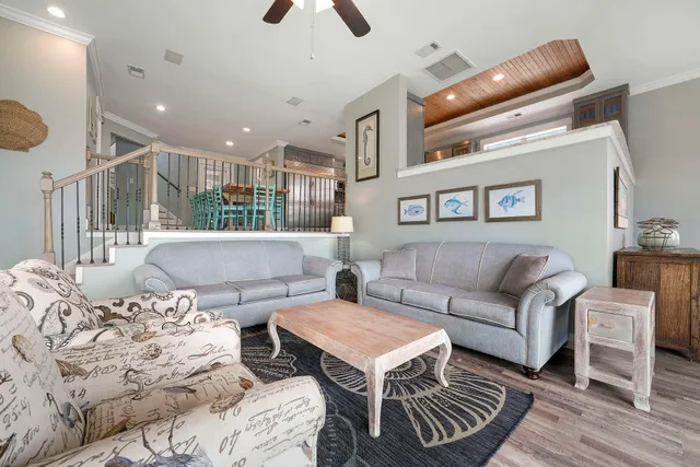 a view of a kitchen with furniture and wooden floor